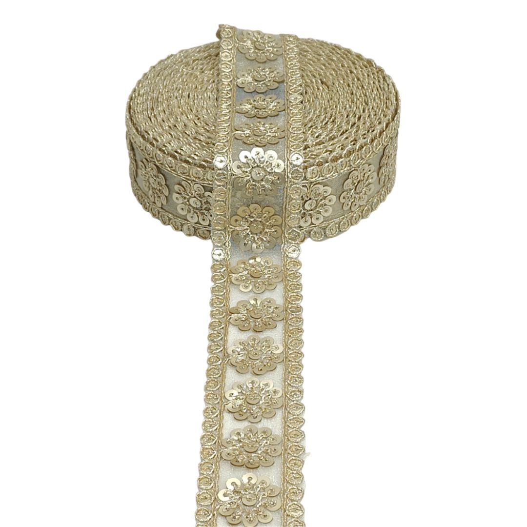 Decorative fabric trim with gold floral embroidery on a white background