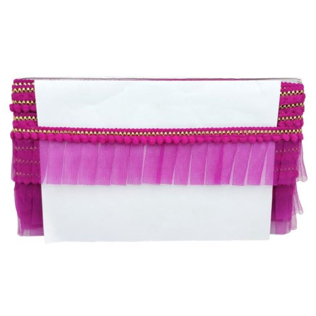 White clutch with pink tassels and trim on a white background