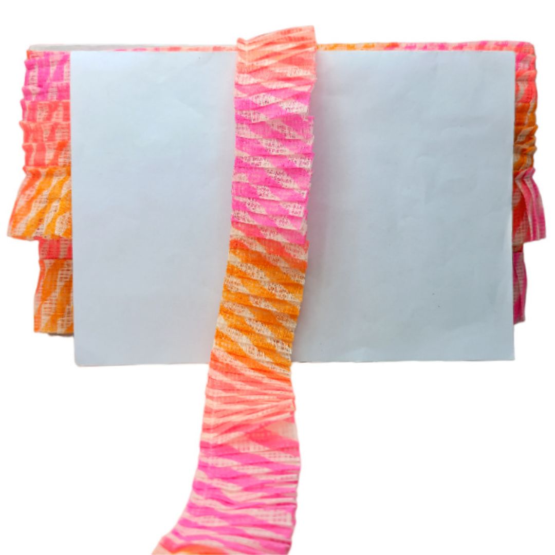 Colorful striped fabric with pink, orange, and white pattern on a white background