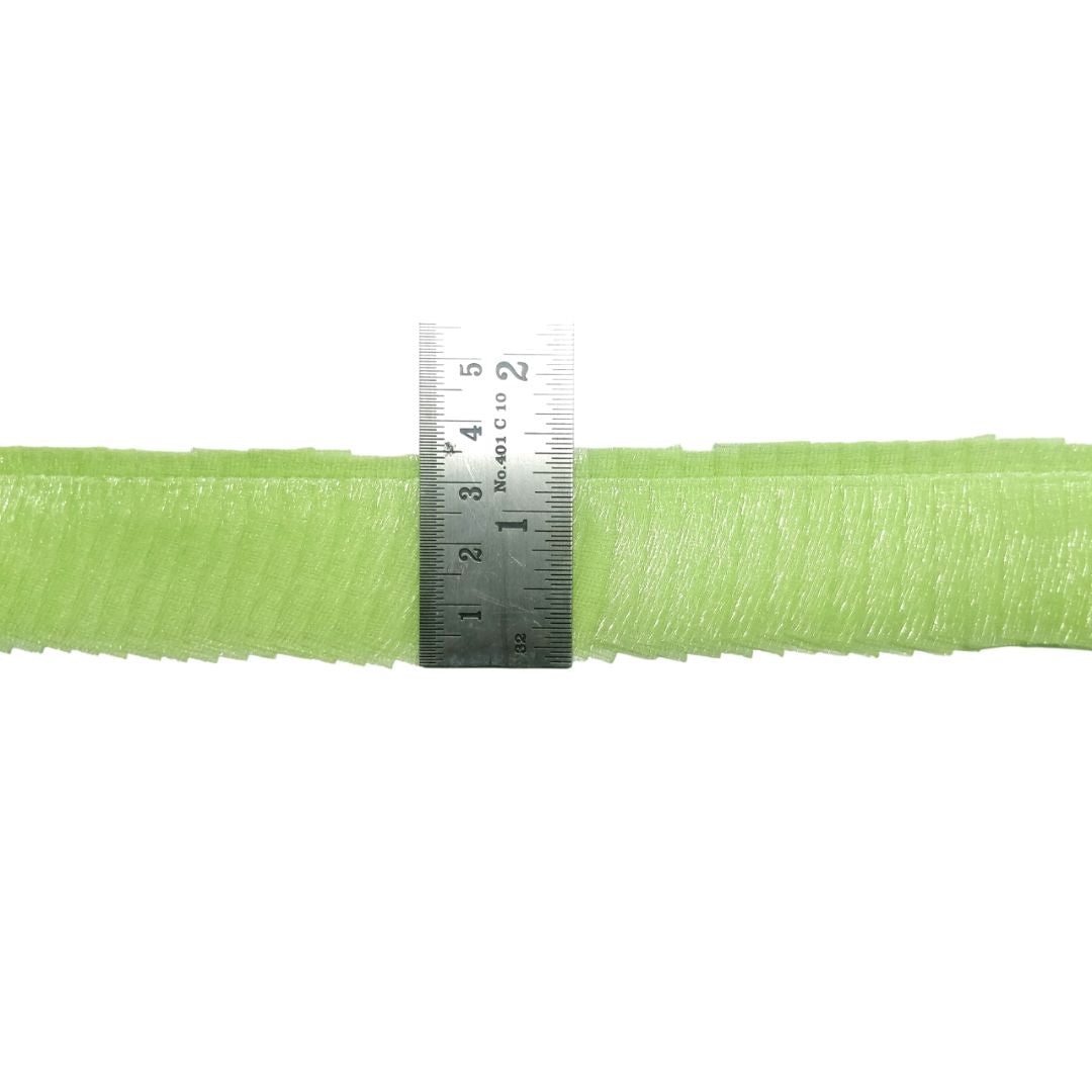 Green mesh ribbon with a ruler for scale on a white background