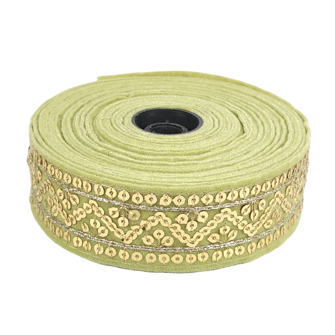 Roll of green ribbon with gold lace on a white background