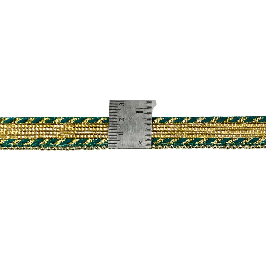 Gold and green striped ribbon with a ruler for scale on a white background