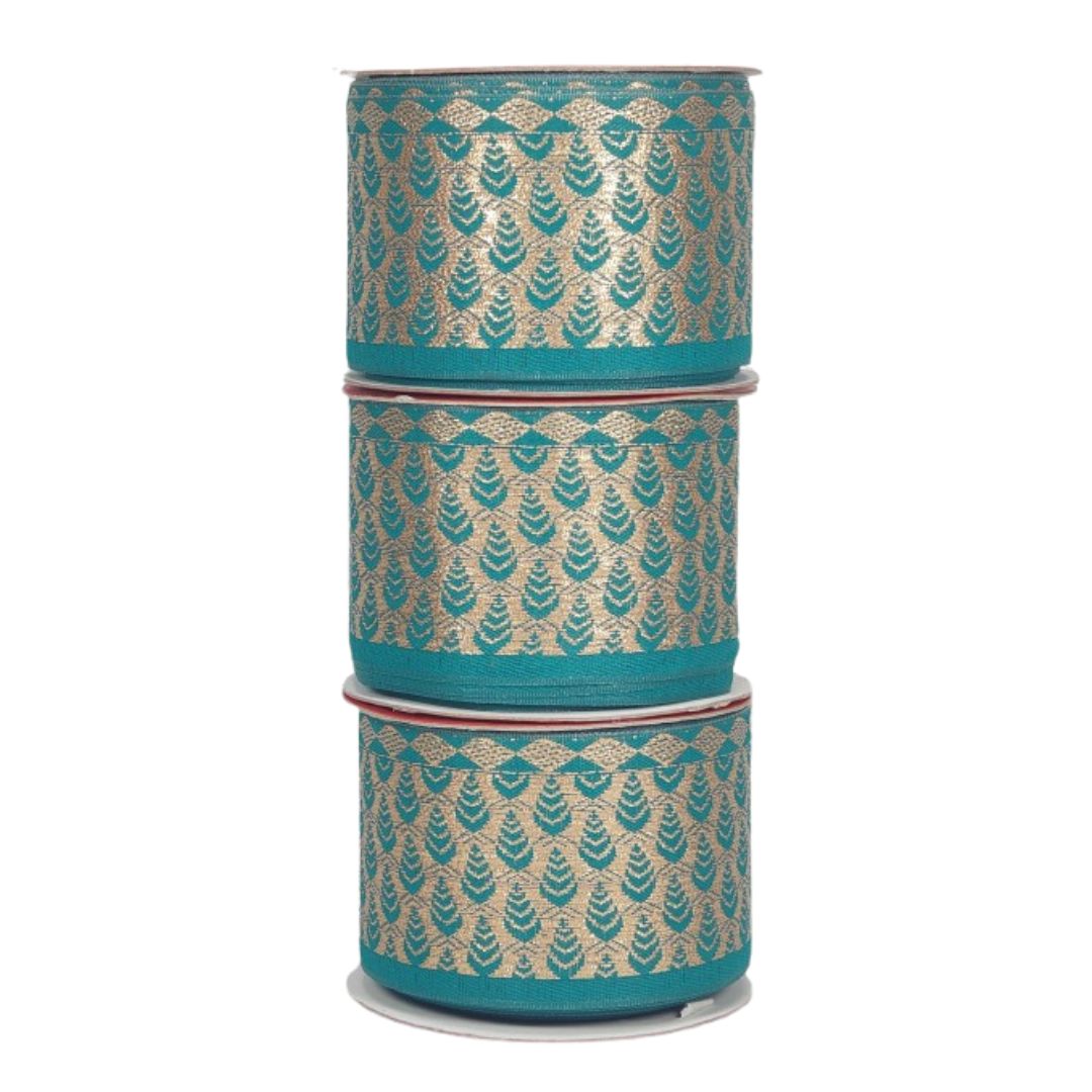 Three spools of teal ribbon with gold leaf pattern on a white background