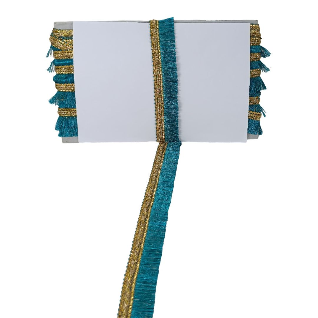 Decorative table runner with teal and gold fringe on a white background