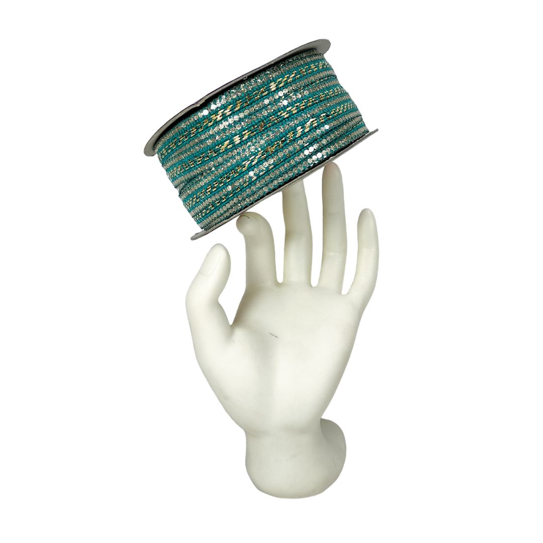Spool of teal and gold ribbon on a white mannequin hand