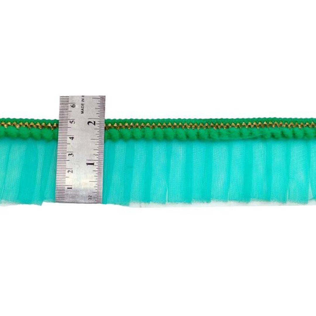Green and turquoise ribbons with a ruler for measurement on a white background