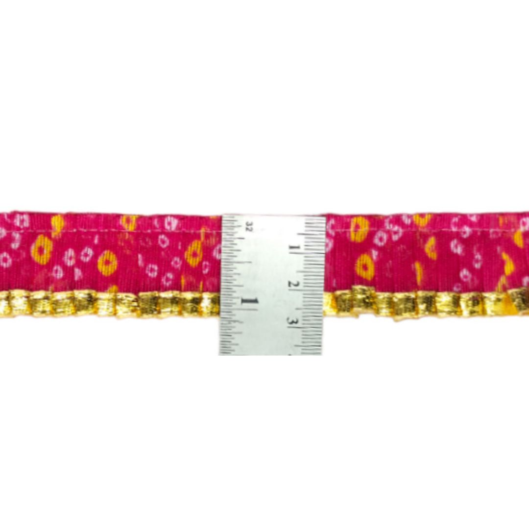 Pink belt with gold trim and floral pattern, shown with a ruler for size reference.