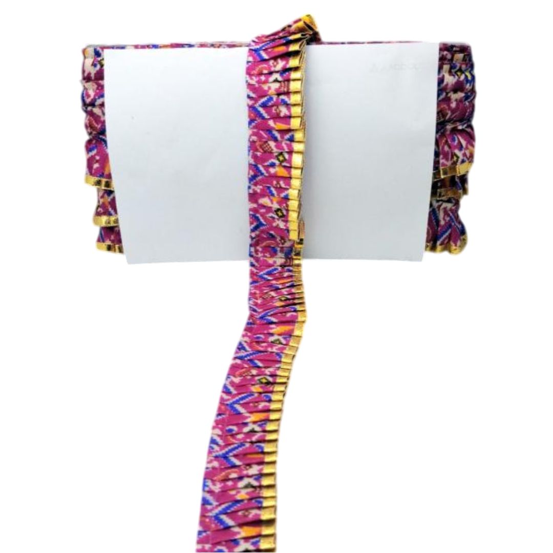 Colorful fabric with geometric pattern draped over a white surface