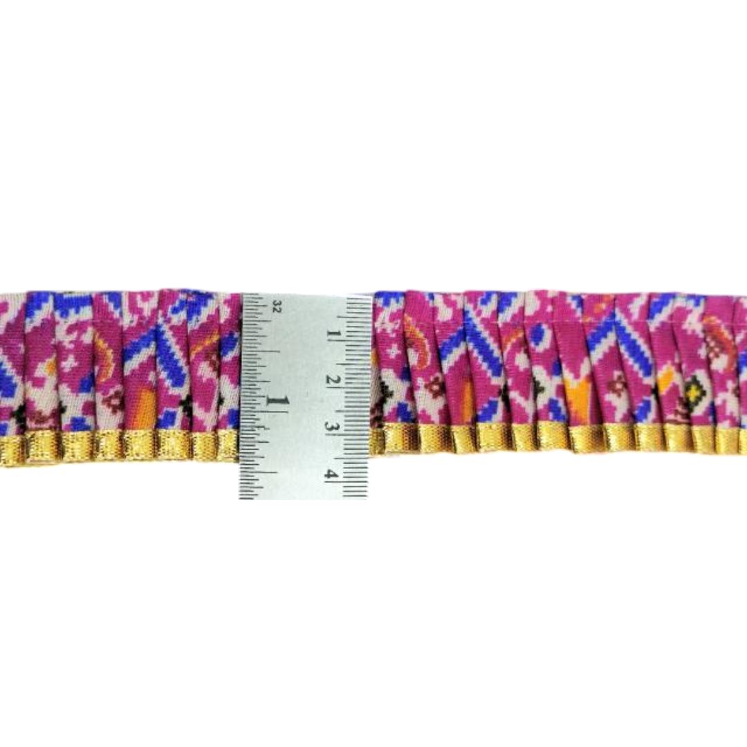 Multicolored fabric border with a ruler for scale on a white background