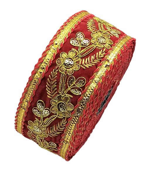 Red fabric roll with gold embroidery on a white background