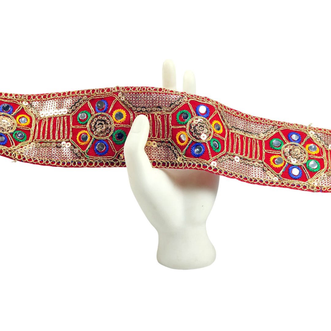 Decorative headband with colorful gemstones on a mannequin head against a white background