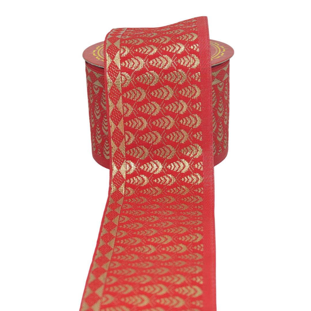 Red ribbon with gold geometric pattern on a white background
