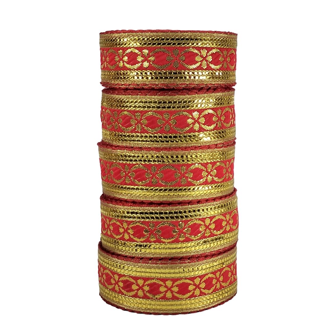 Set of red and gold bangles stacked on a white background