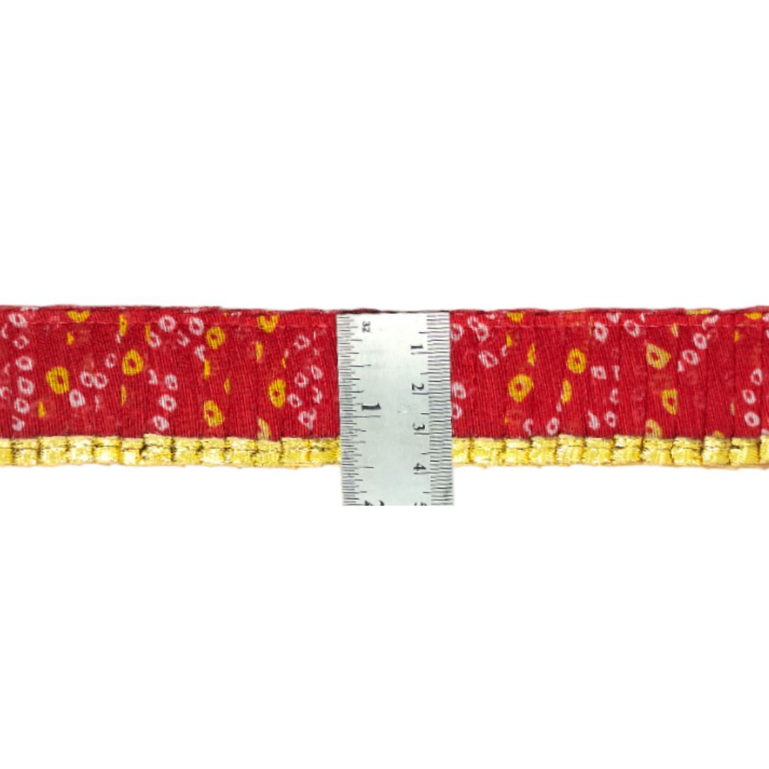 Red belt with yellow floral pattern and silver buckle on a white background