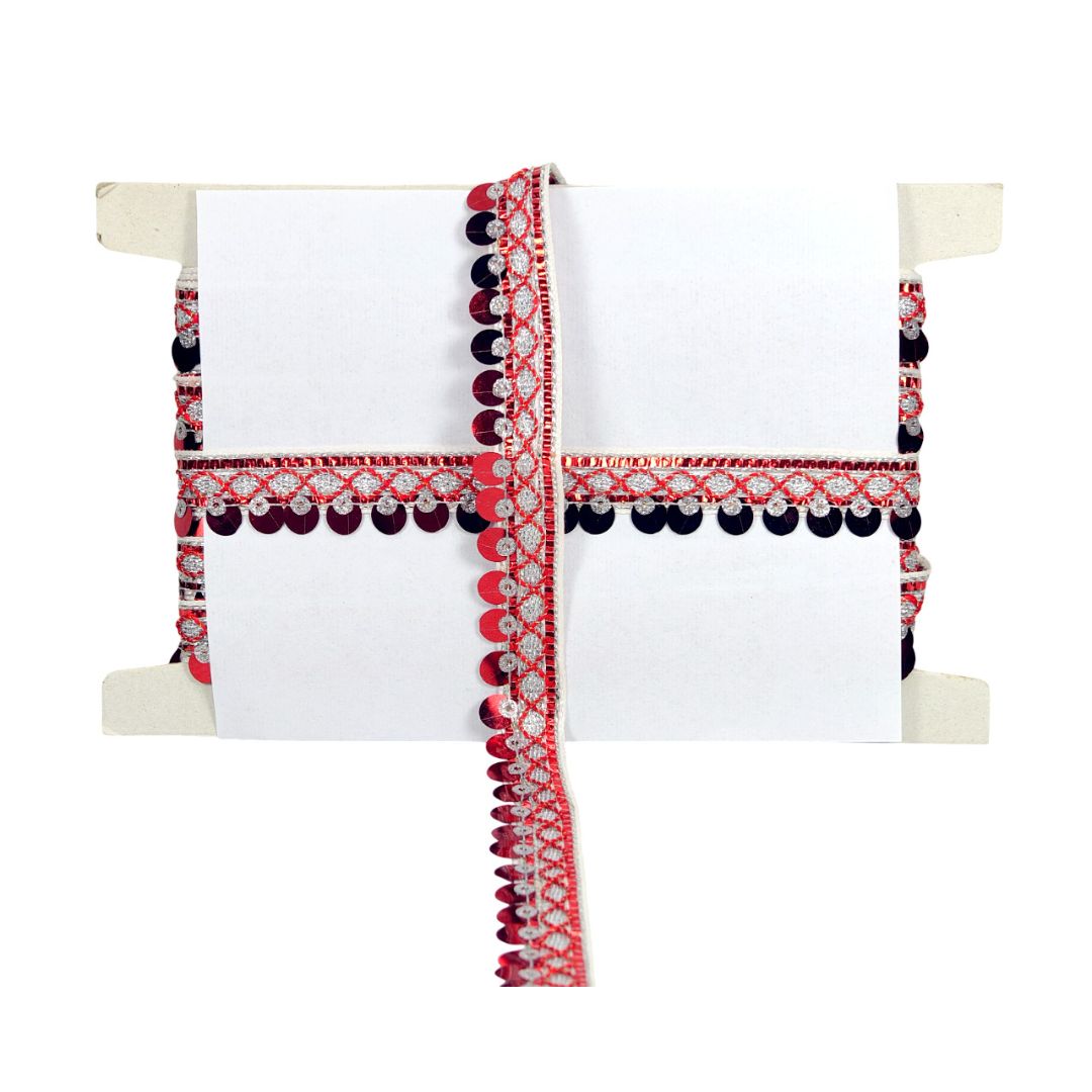 Decorative white pillow with red and black pattern on a white background