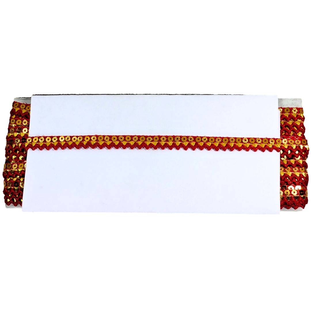 White tablecloth with red and gold sequin border on a white background