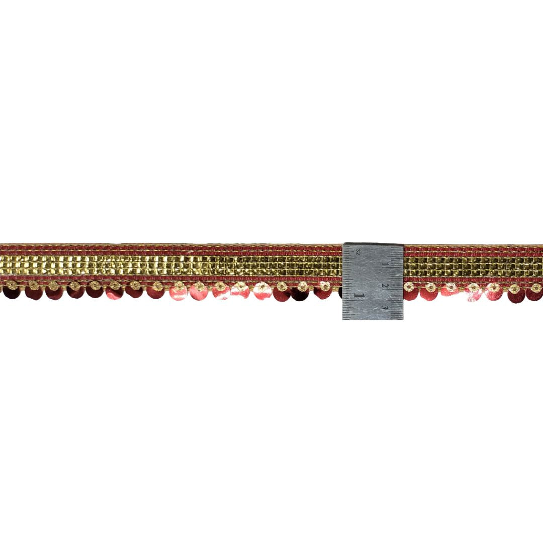 Decorative ribbon with beads and a ruler for scale on a white background