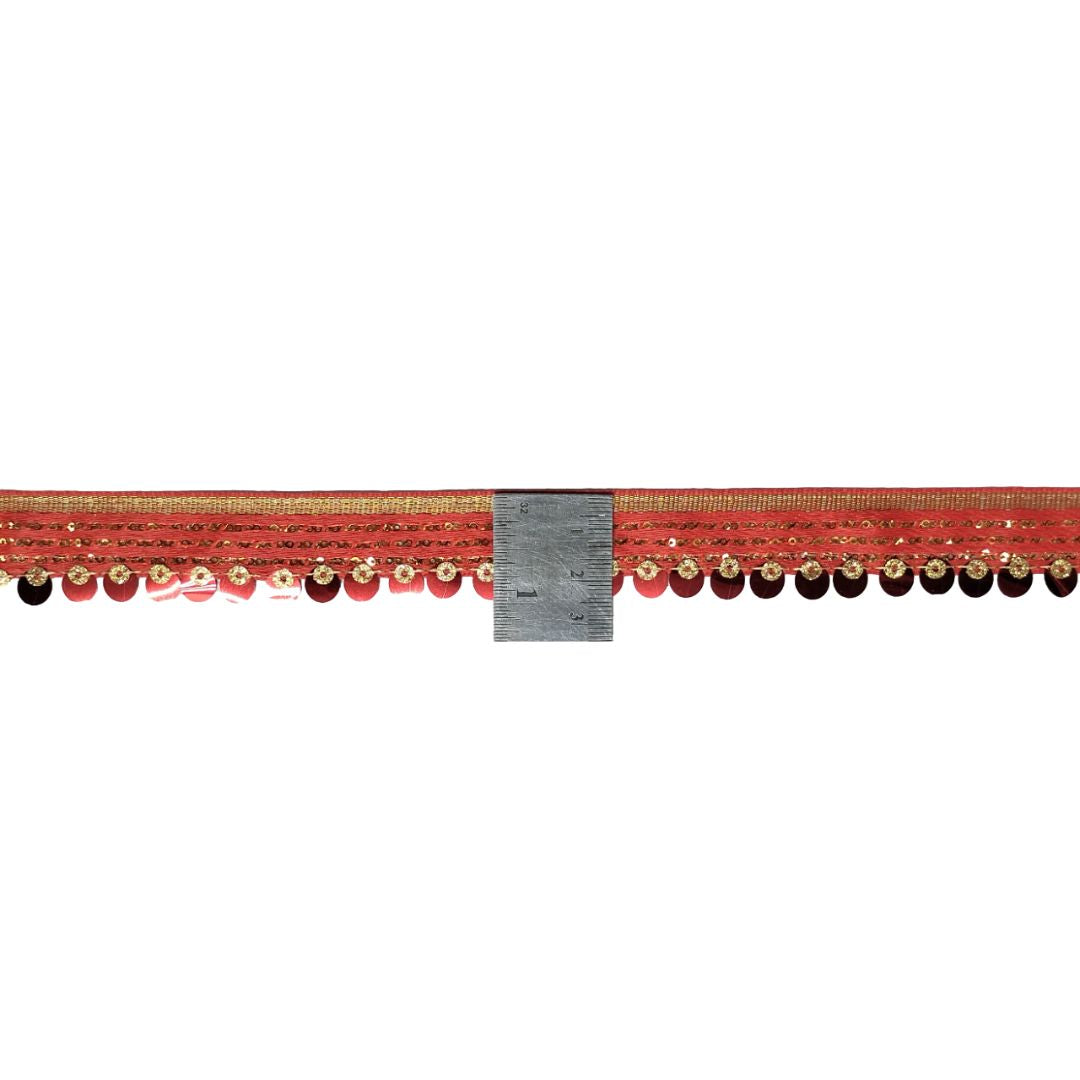 Red decorative cornice with gold trim and black beads on a white background