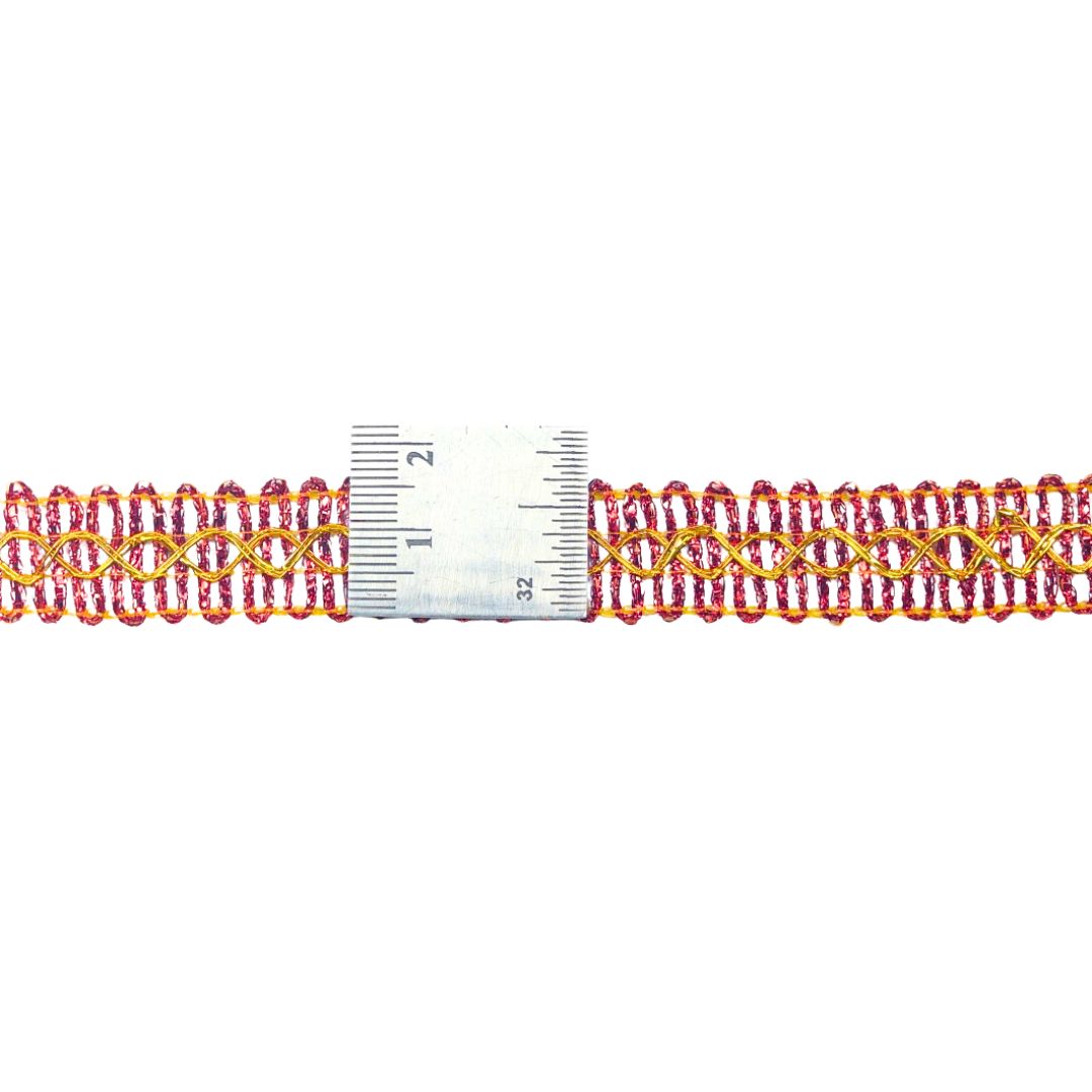 Red and gold braided trim with a ruler for scale on a white background