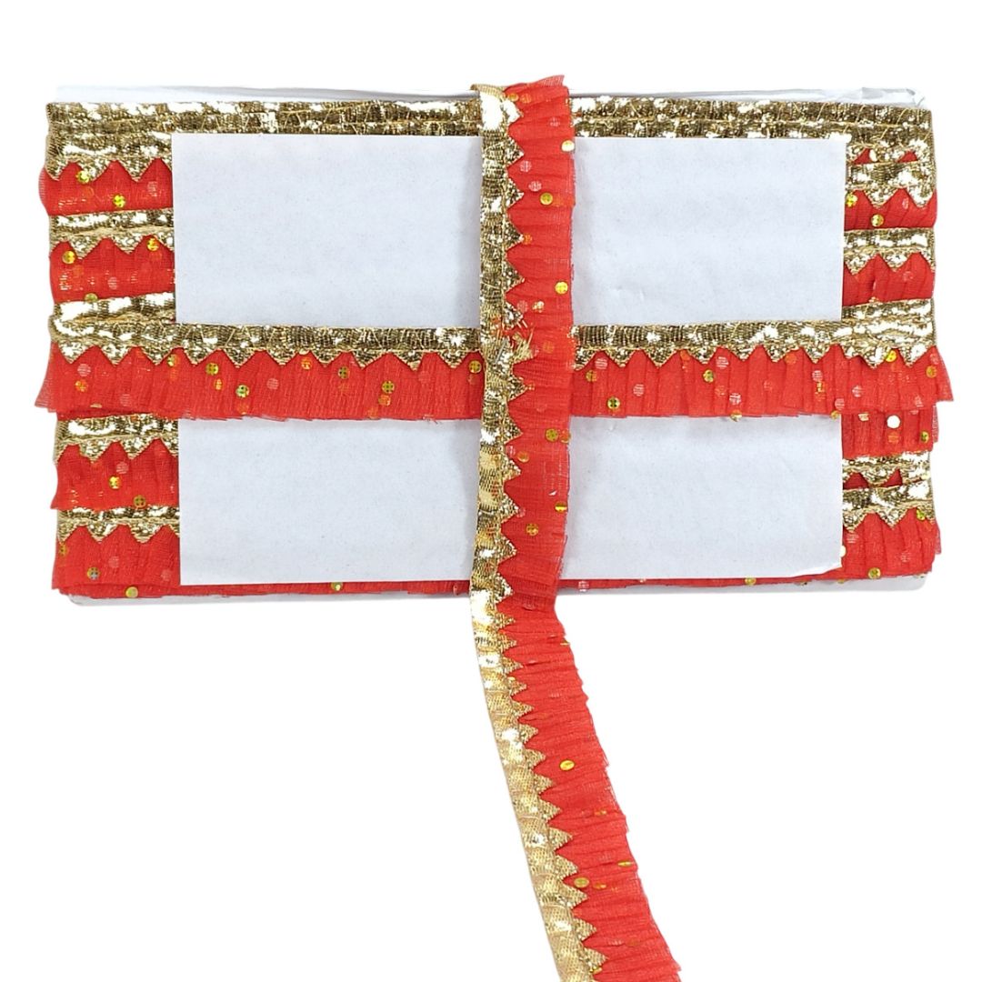 Red and gold decorative fabric with white center on a white background