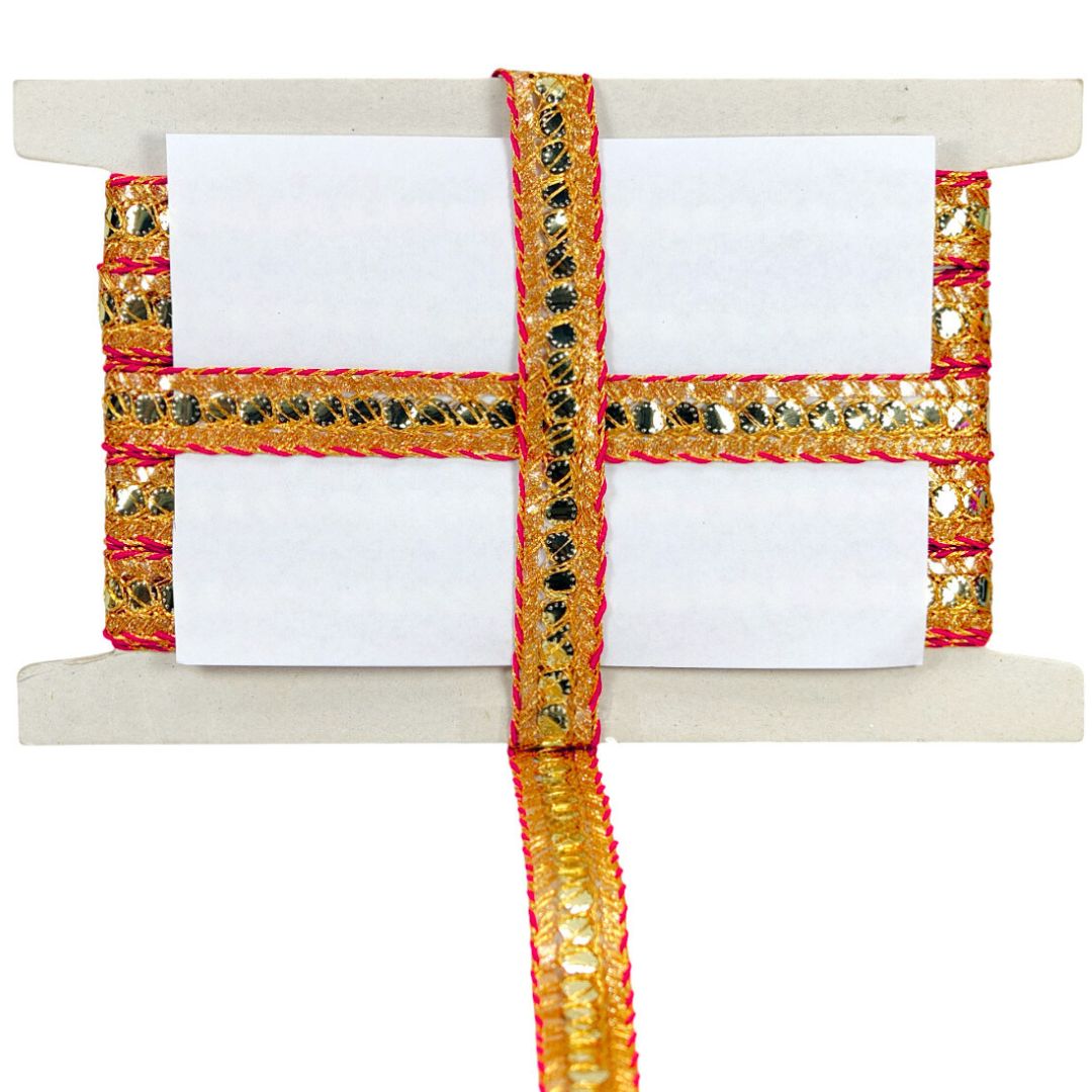 Decorative ribbon with gold and red patterns on a white background