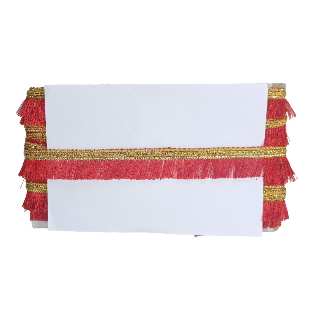 White tablecloth with red and gold fringe on a white background