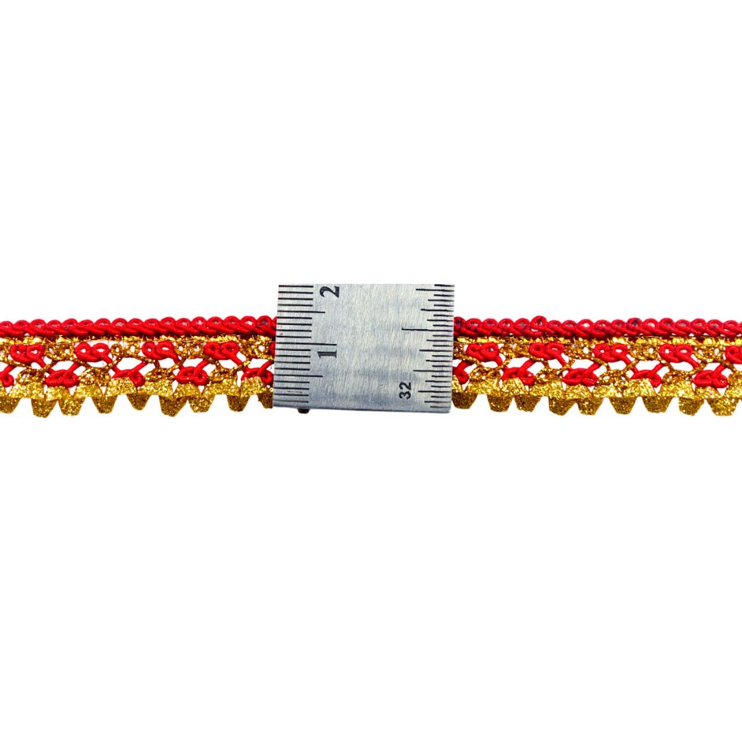 Red and gold lace trim with a ruler for measurement on a white background