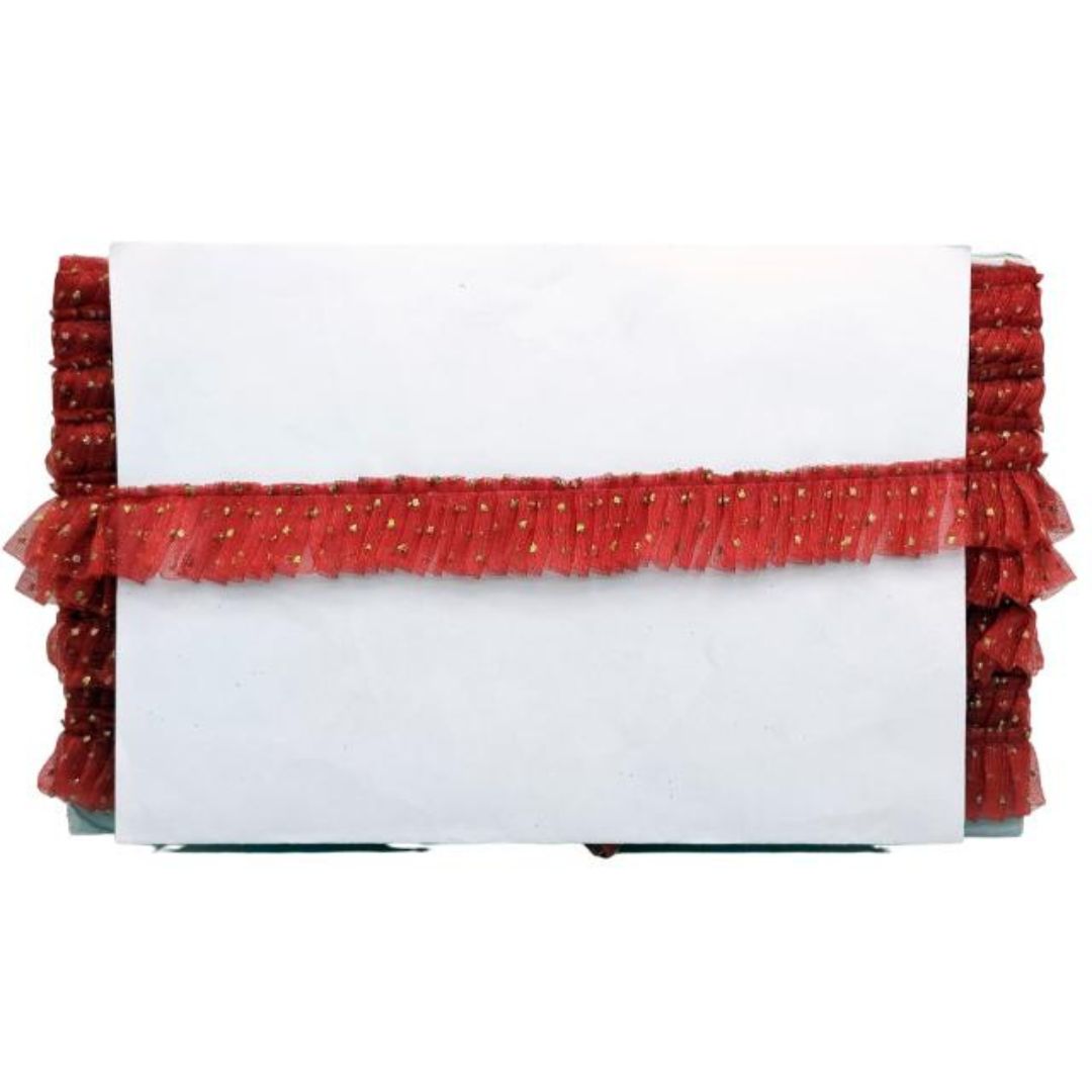 White clutch with red ruffled trim on a white background