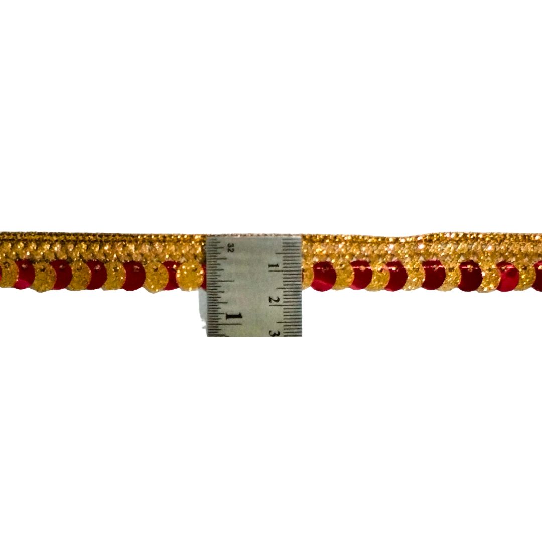 Gold and red decorative trim with a ruler for scale on a white background