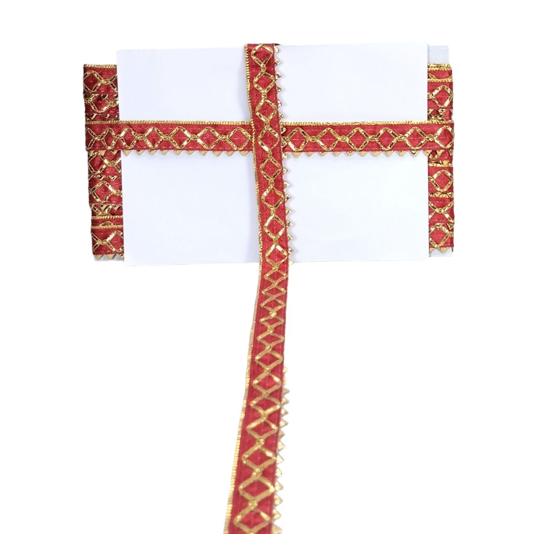 Decorative red and gold cross on a white background