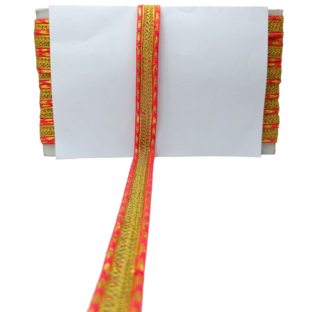 Decorative headband with red and gold patterns on a white background