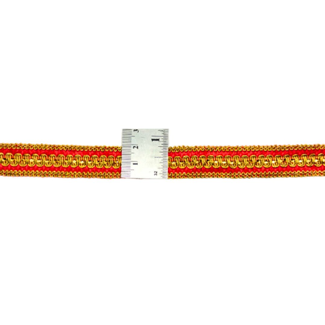 Red and gold braided cord with a measuring scale on a white background
