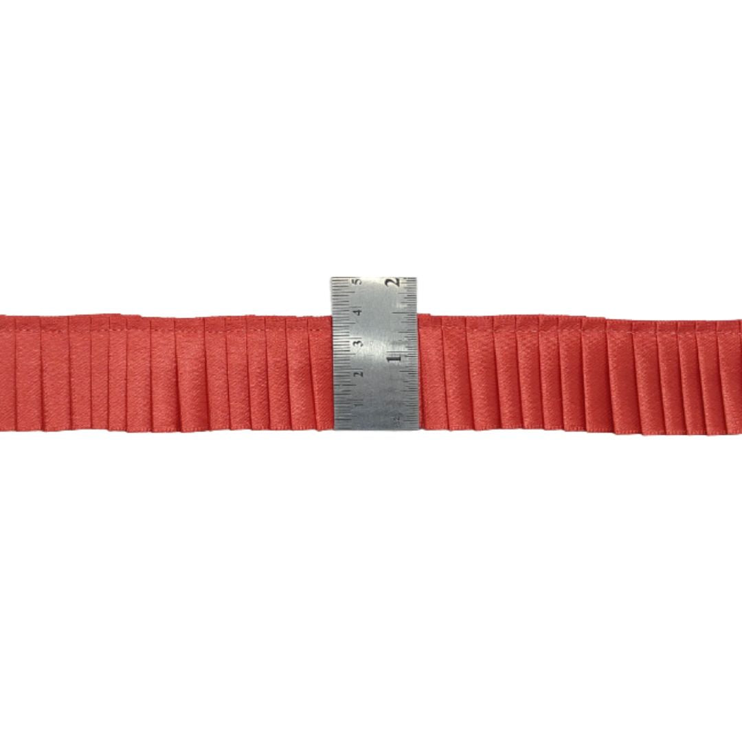 Red belt with a metal ruler on a white background
