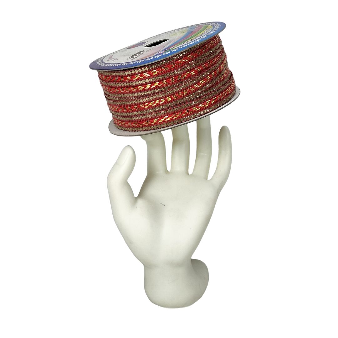 Spool of red and gold ribbon on a white mannequin hand