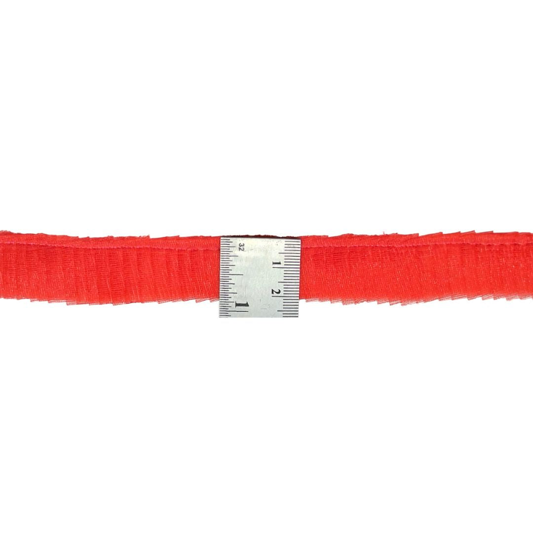 Red ribbon with a silver measuring tape on a white background