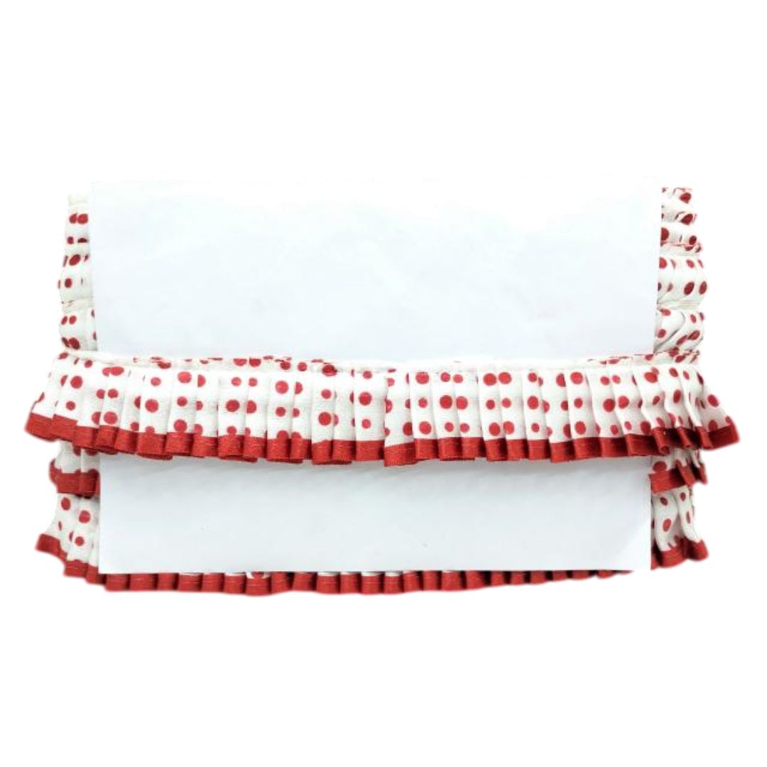 Red and white polka dot baby crib bumper with ruffles on a white background