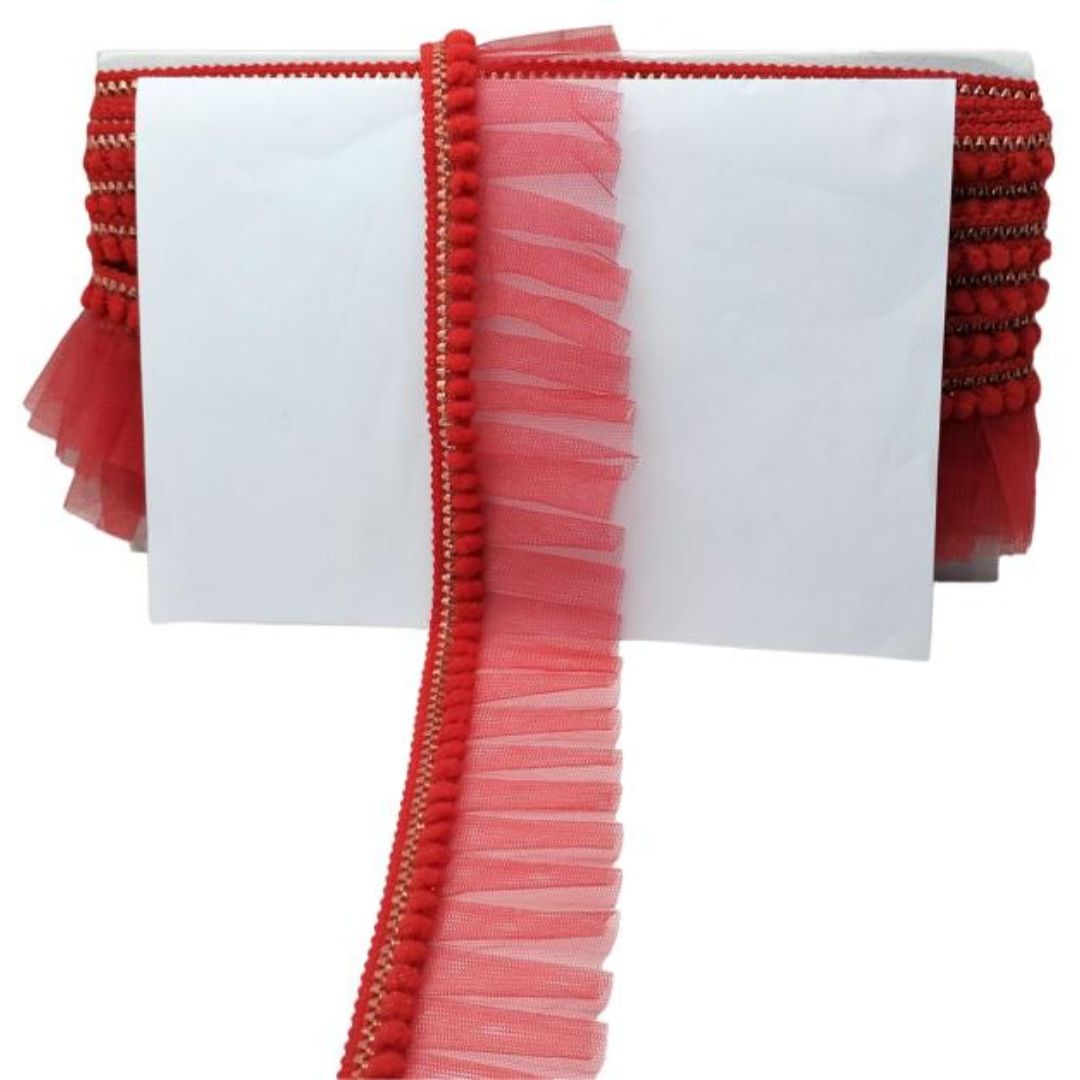 Red and pink ribbons with decorative edges on a white background