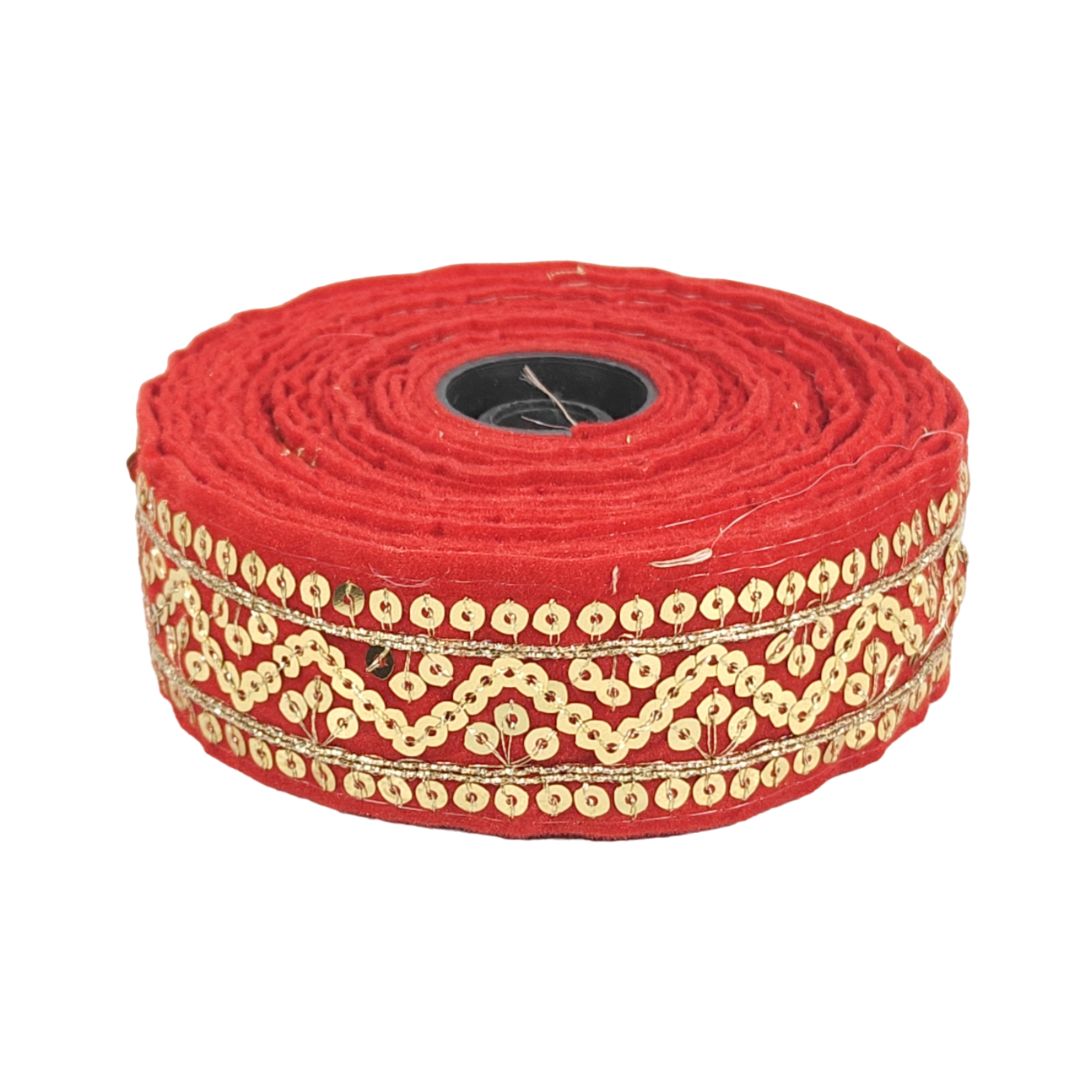 Red ribbon with gold decorative trim on a white background