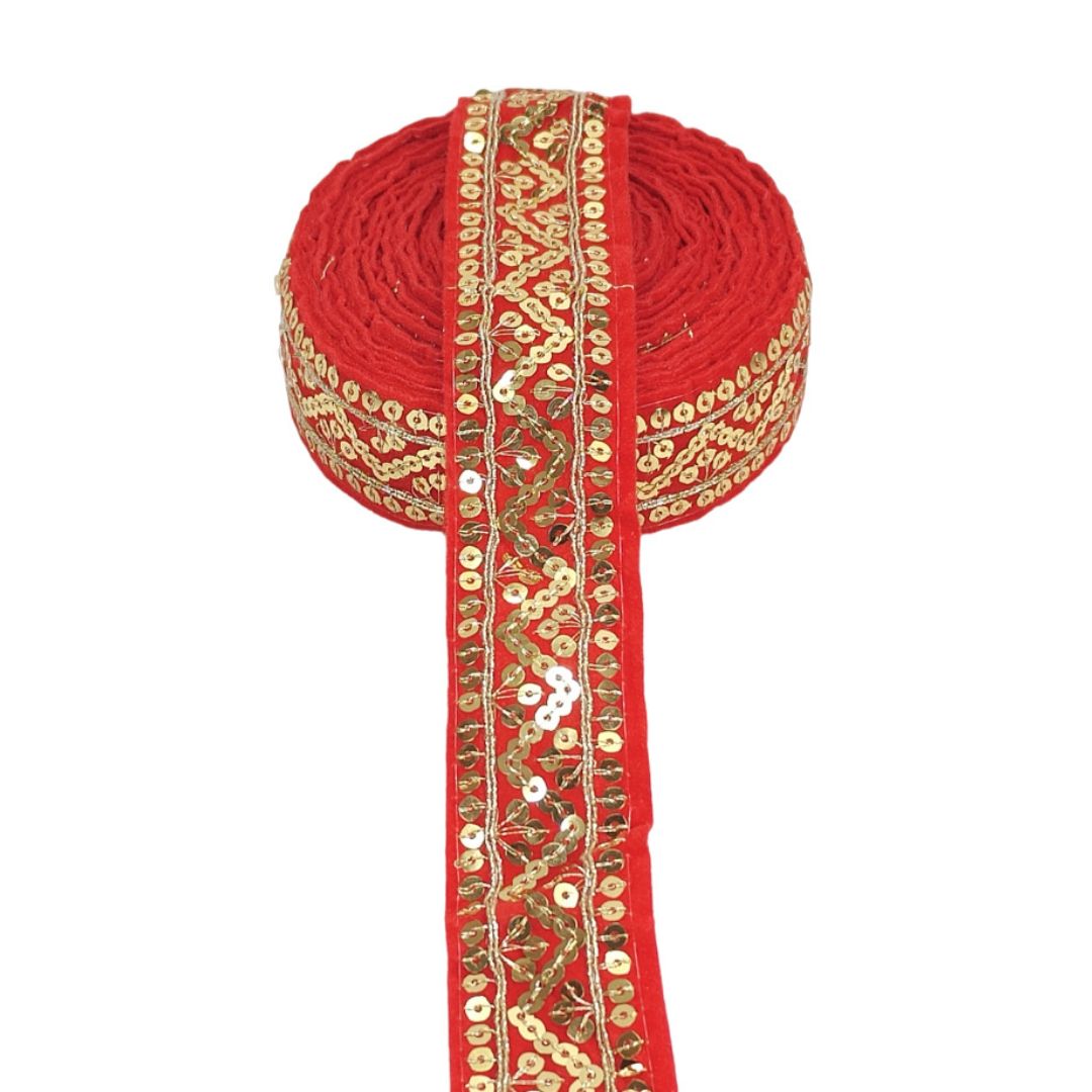 Red fabric with gold embroidery on a white background