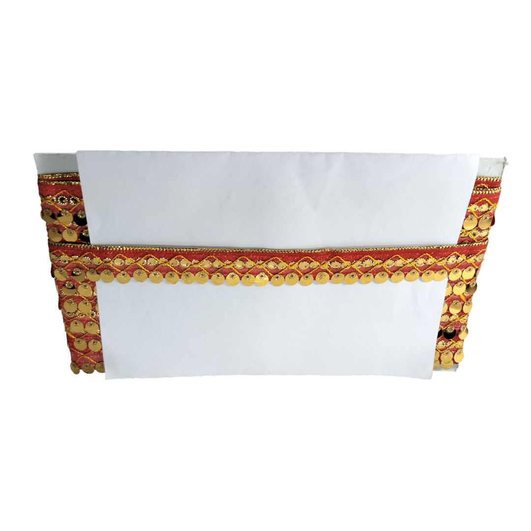 White table runner with red and gold decorative trim on a white background