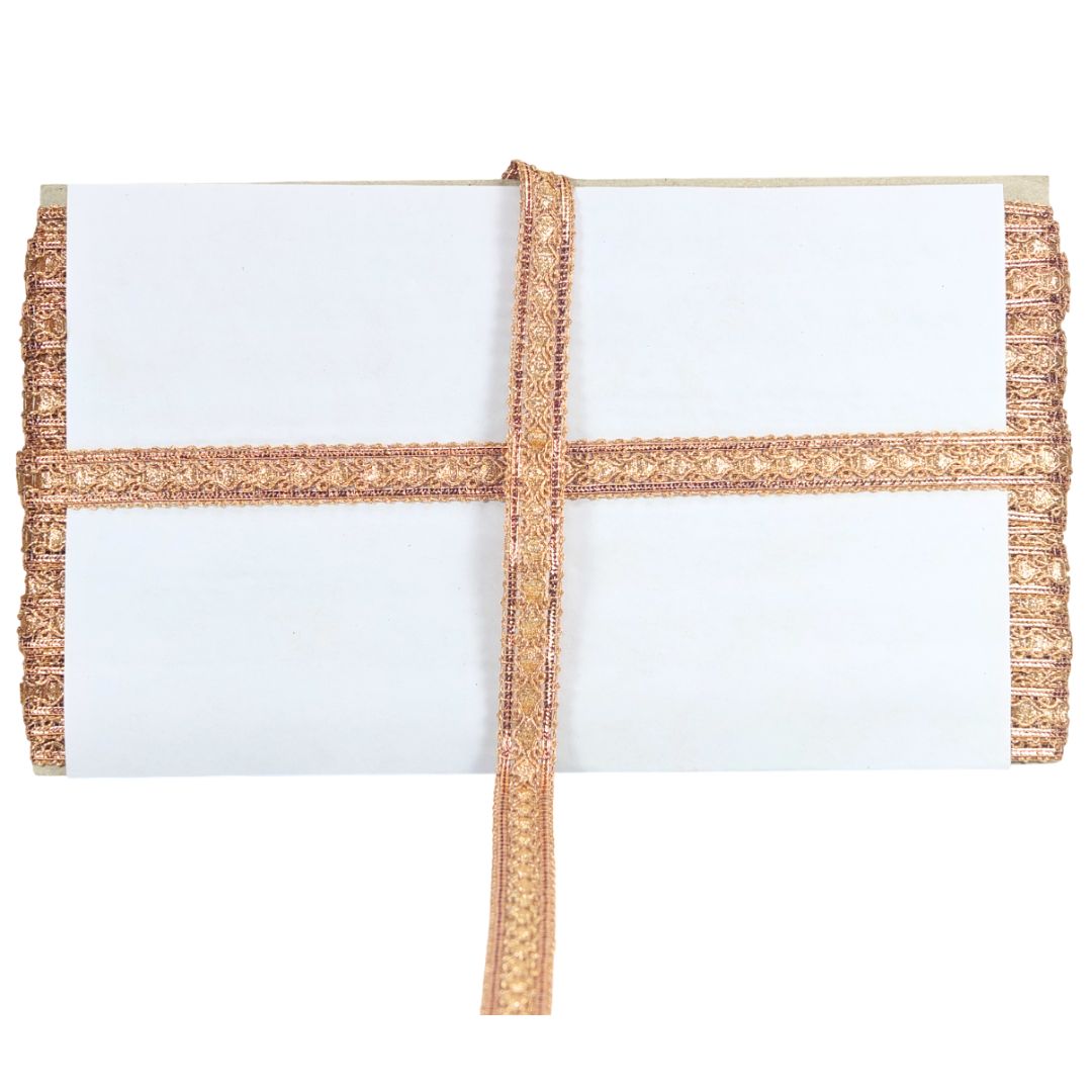 White clutch with gold decorative trim on a white background