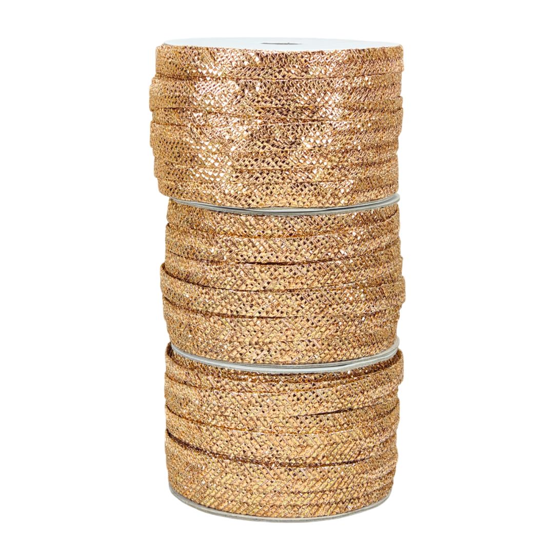 Spool of gold glitter ribbon on a white background