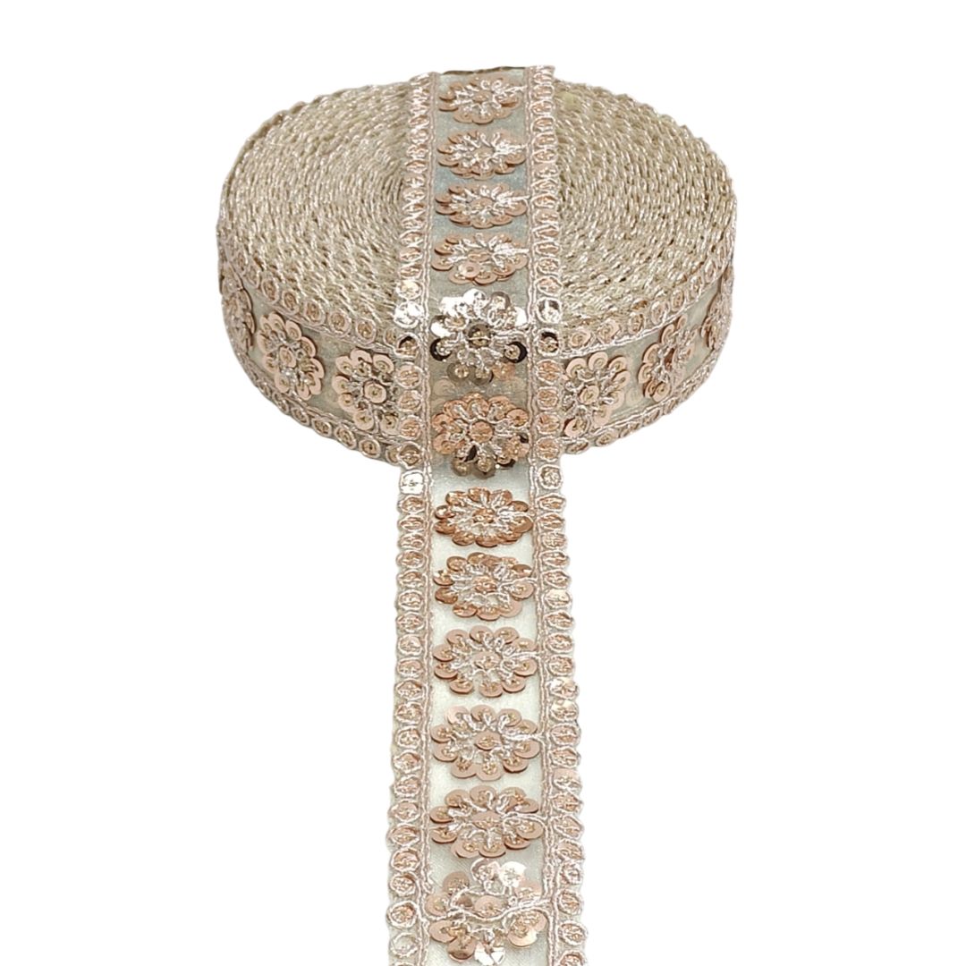 Decorative headpiece with floral patterns and a long ribbon on a white background