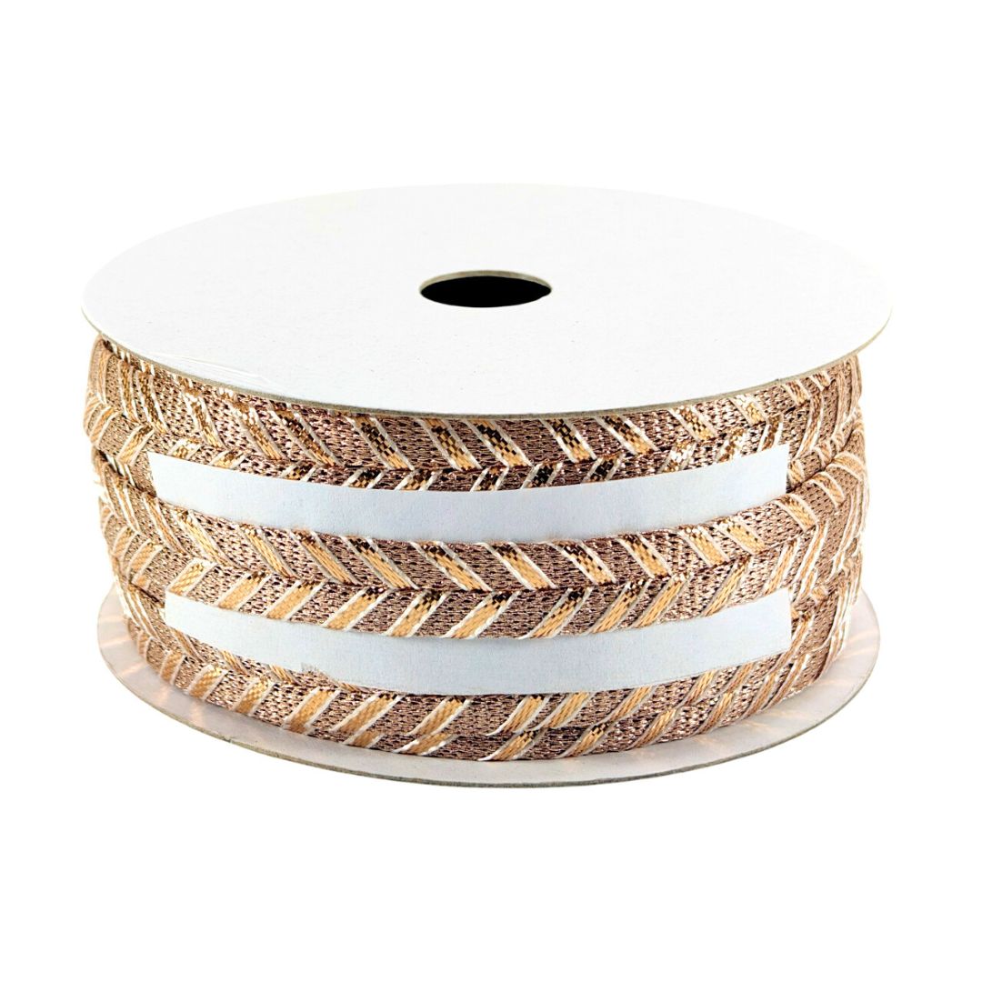 Spool of ribbon with gold and white pattern on a white background