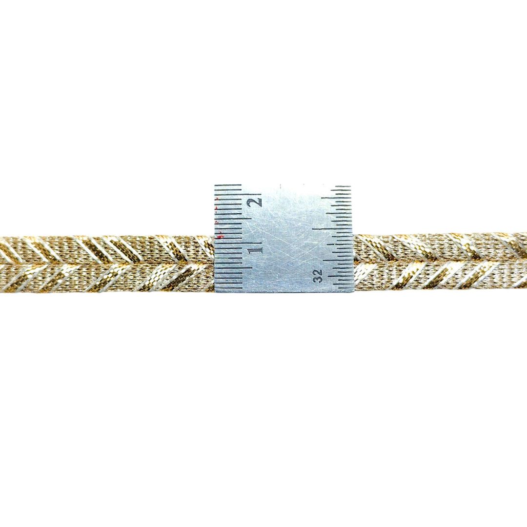Gold braided cord with a ruler for measurement on a white background