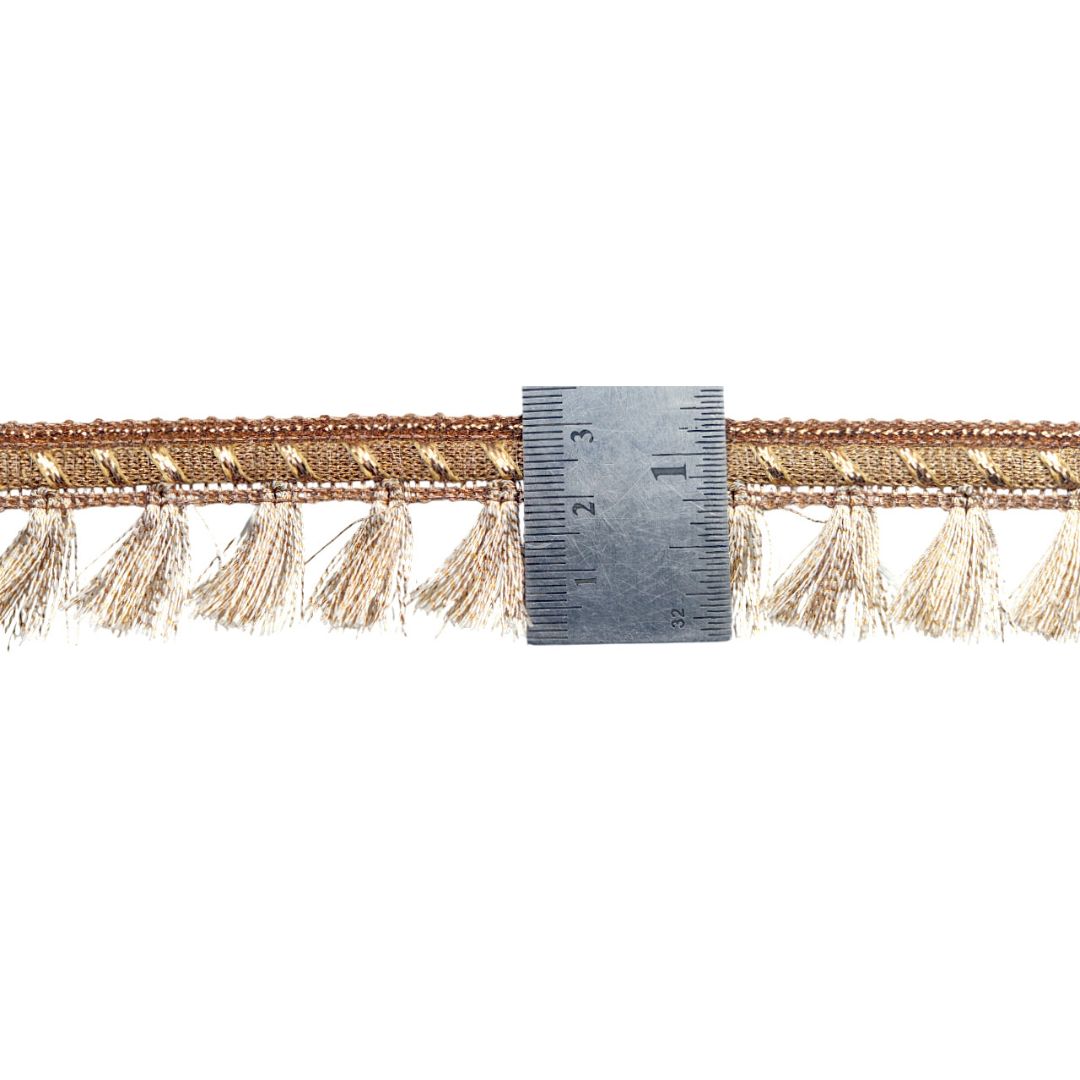 Gold fringe trim with a ruler for measurement on a white background