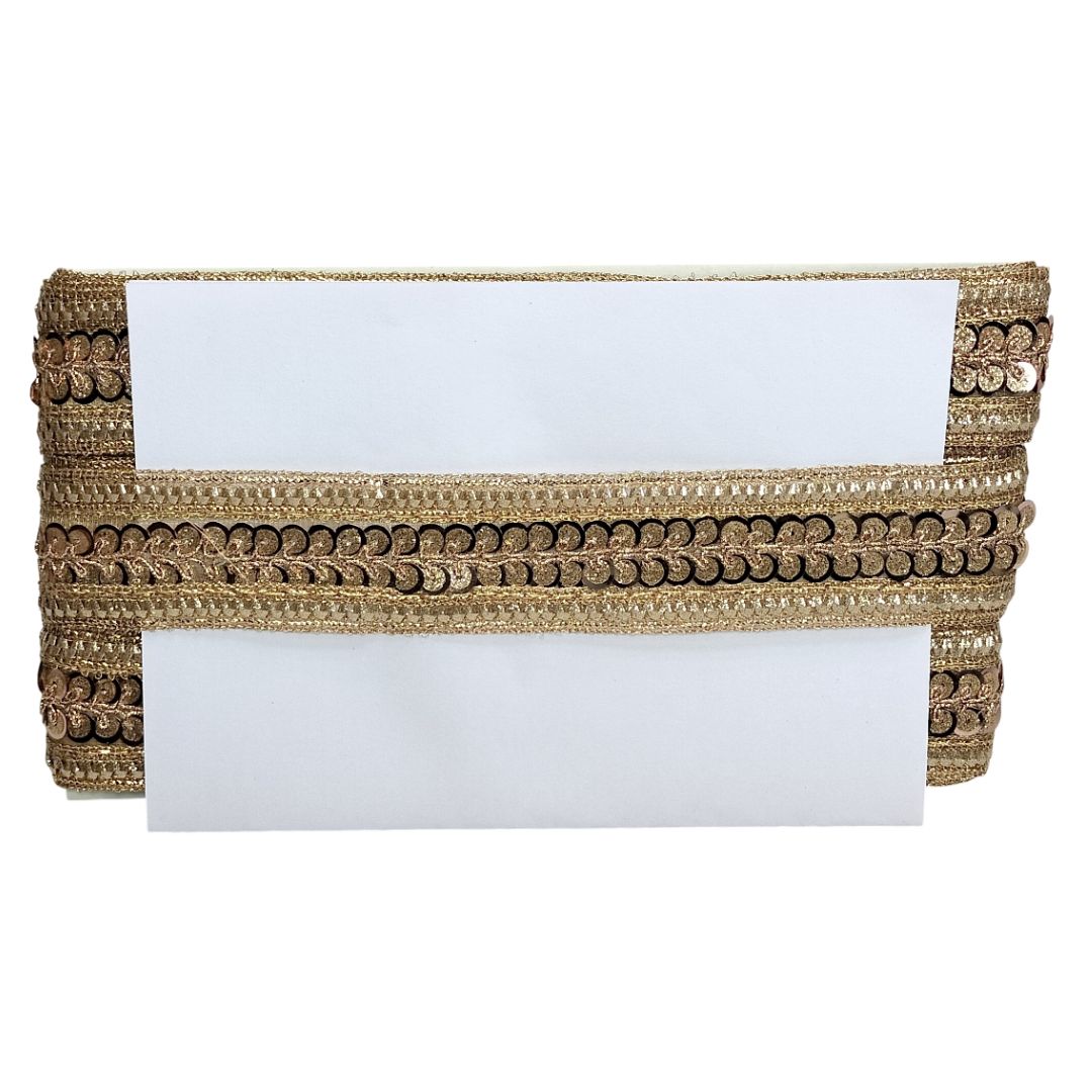 Gold clutch with sequin detailing on a white background