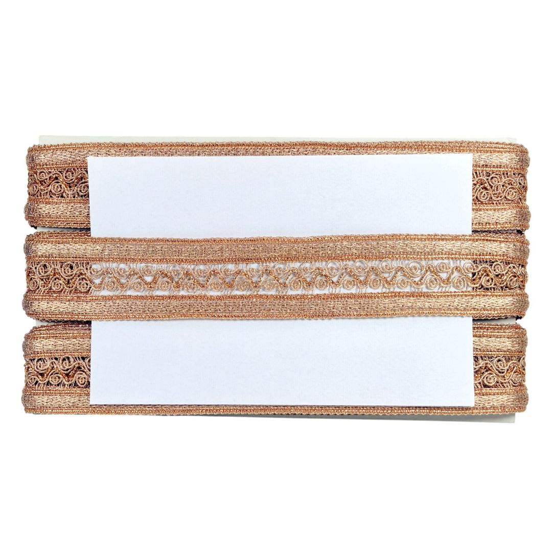 Three rolls of decorative ribbon with a white label on a white background