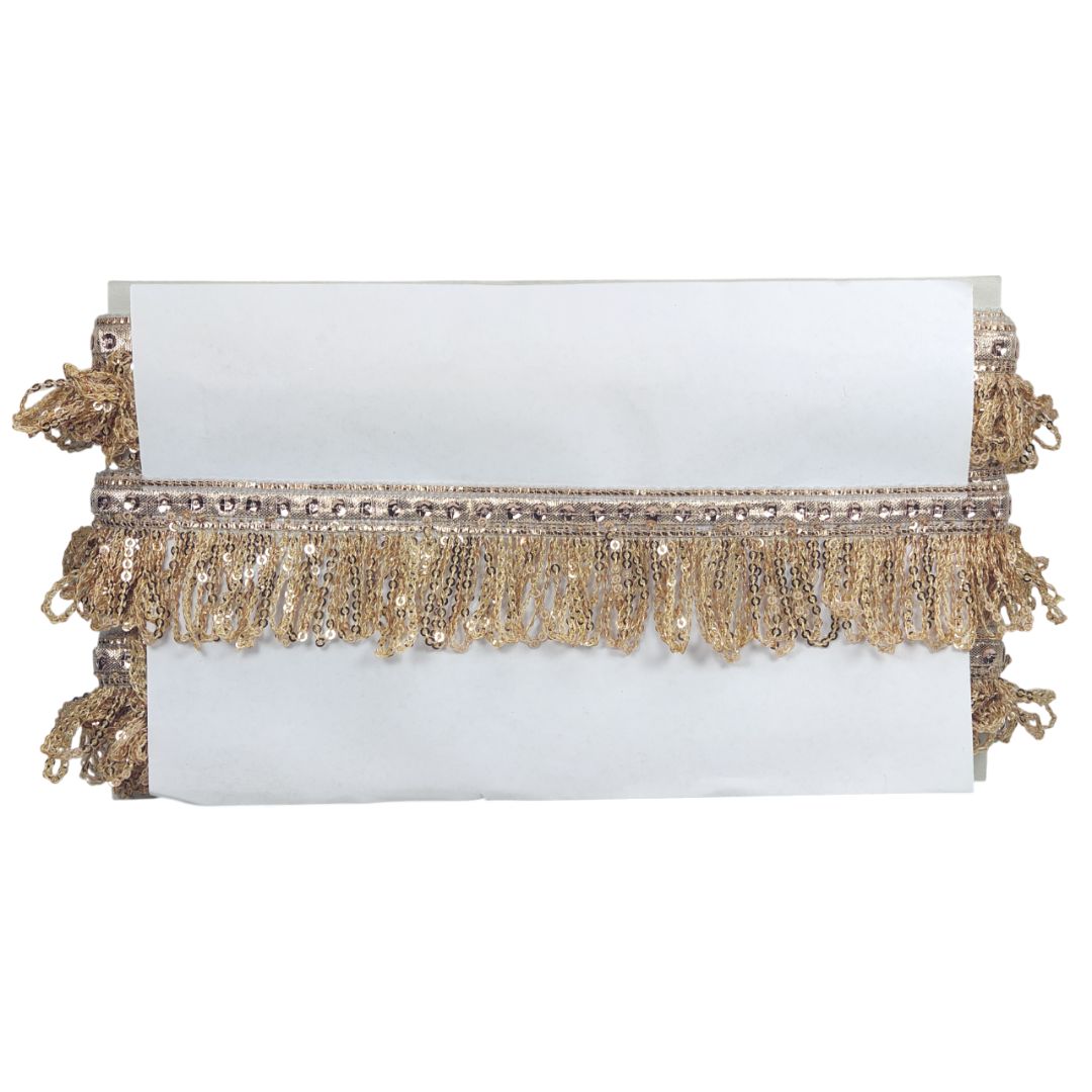White clutch with gold fringe and sequins on a white background