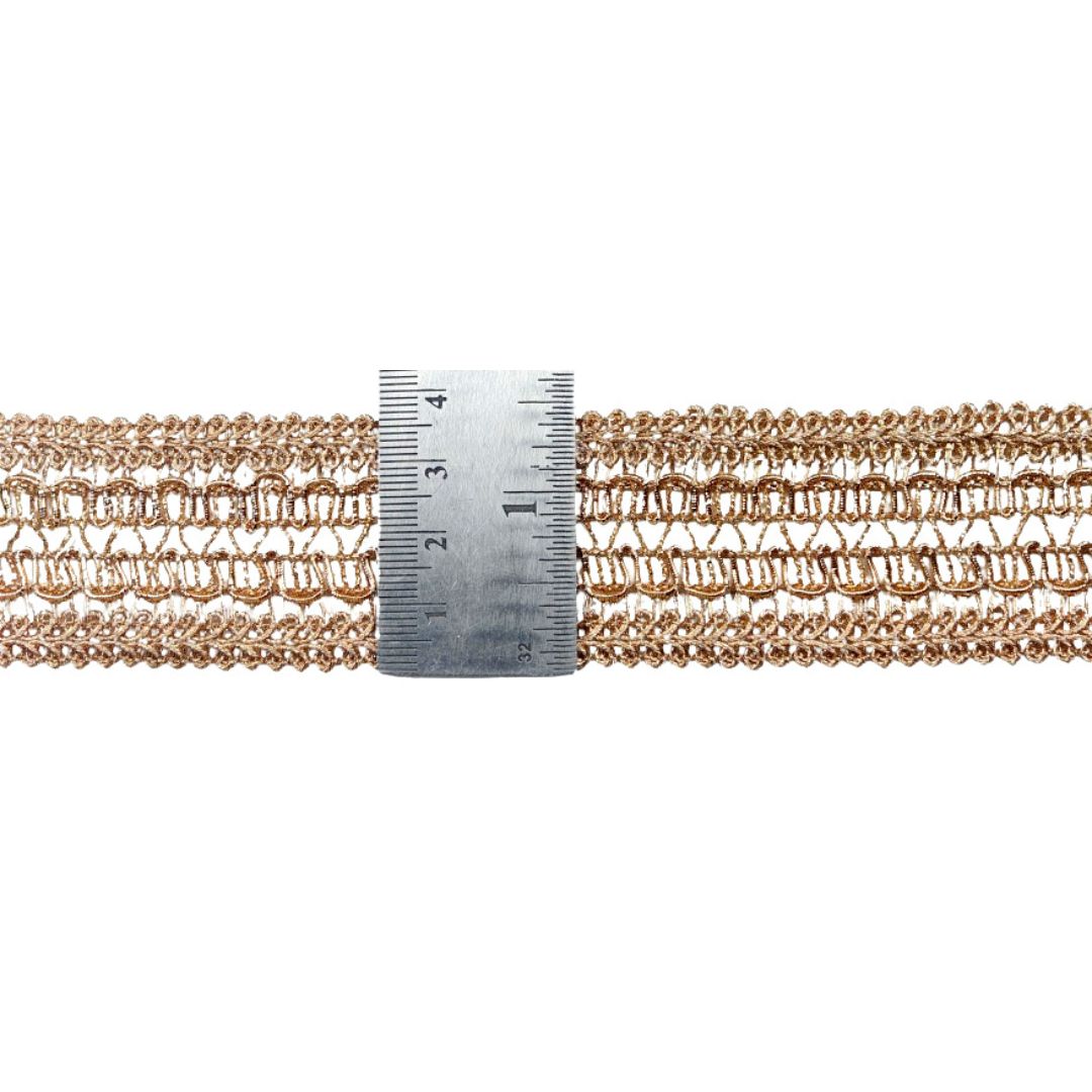 Rose gold chain with a ruler for scale on a white background